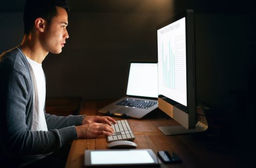 IT Administrator Checking Server Logs On A Monitor