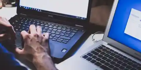 Person Typing On Two Laptops Resized Esm H240